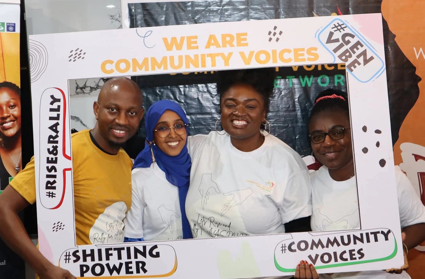 Community Voices photo frame with team members at Rise & Rally event