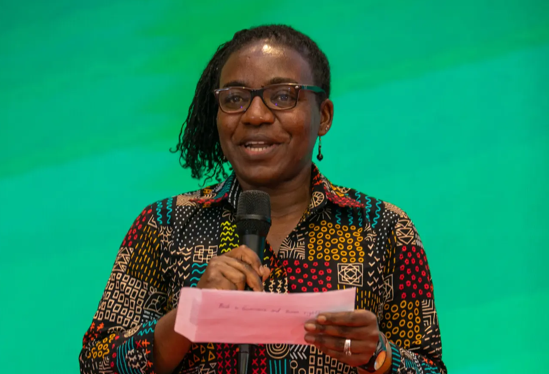 TSB female facilitator in African print speaking at event